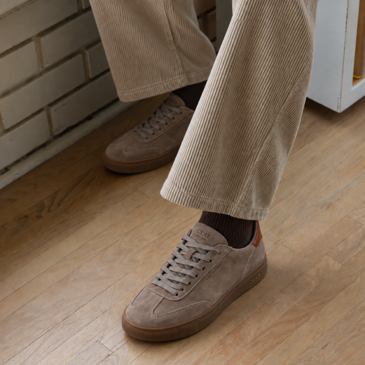 CLAE DEANE Fallen Rock Dark Gum worn with ecru corduroy trousers and chocolate socks