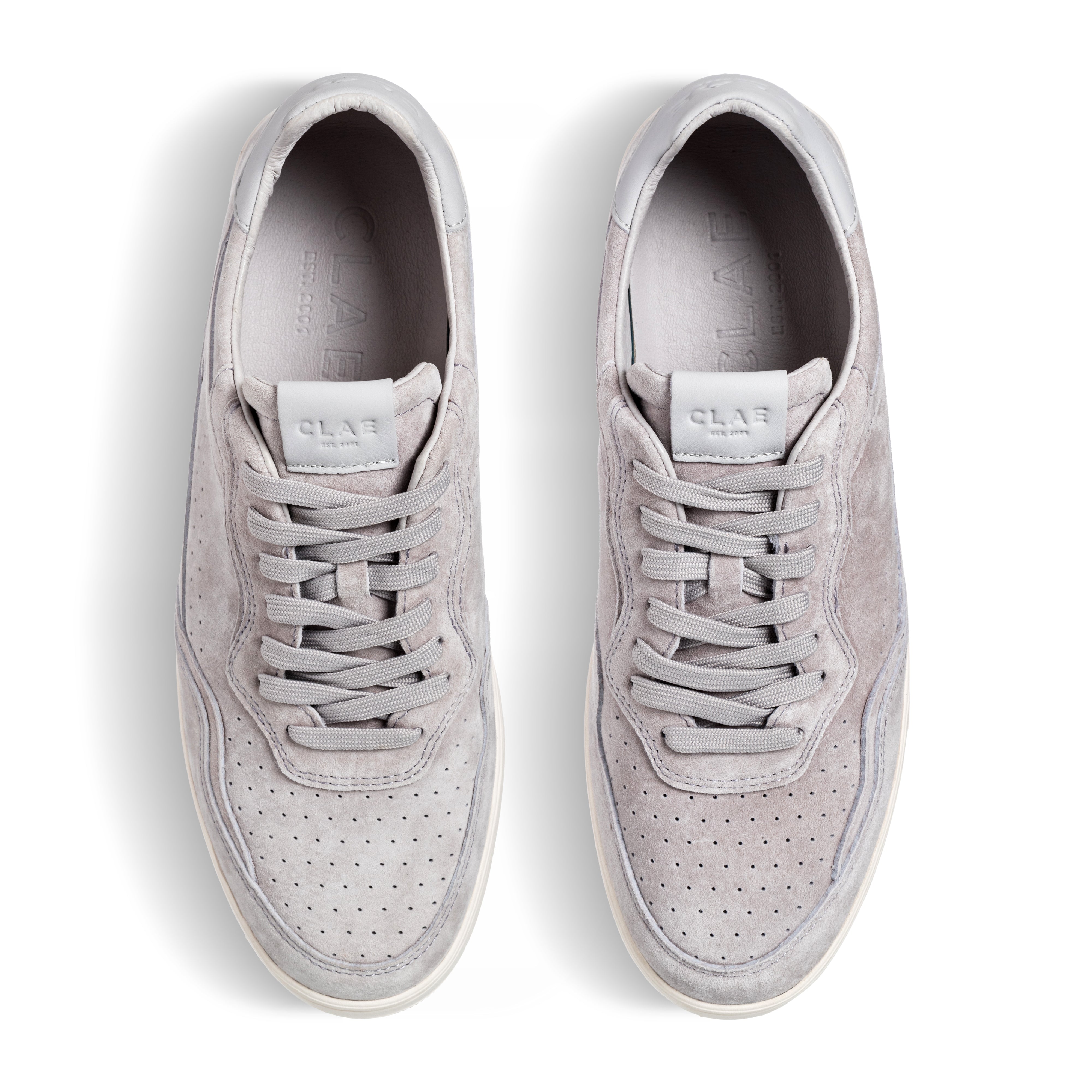 Three-quarter view of Haywood court shoe in Quiet Gray Suede, highlighting all-leather construction and premium finish.