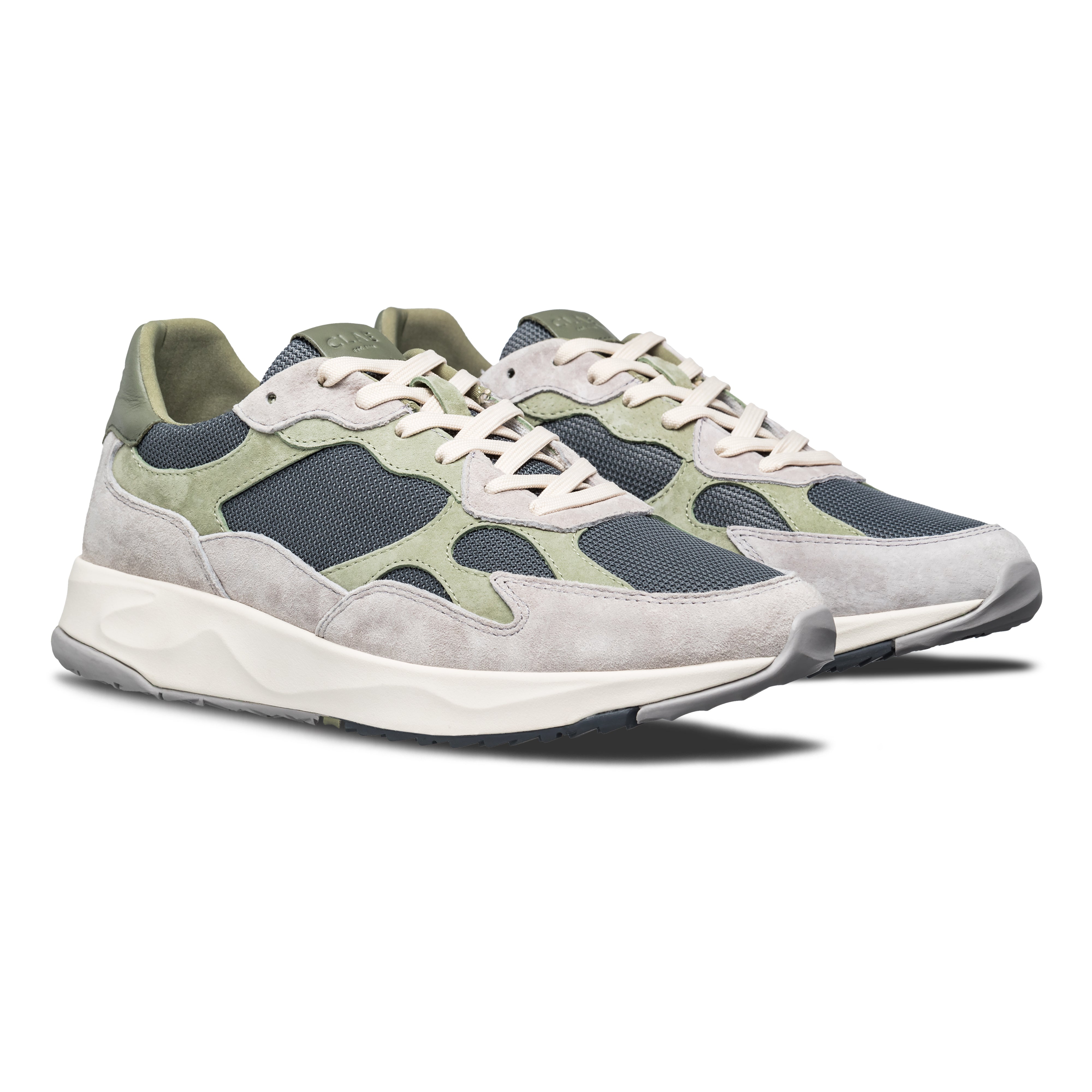 Three-quarter view of Zuma runner in Quiet Gray Tea, highlighting flexible construction and Desert Track outsole design.