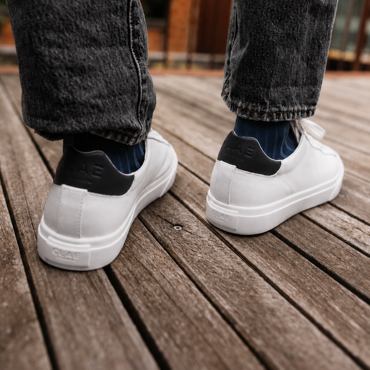 BRADLEY VENICE White Navy White rear view worn with dark jeans on a wooden terrace