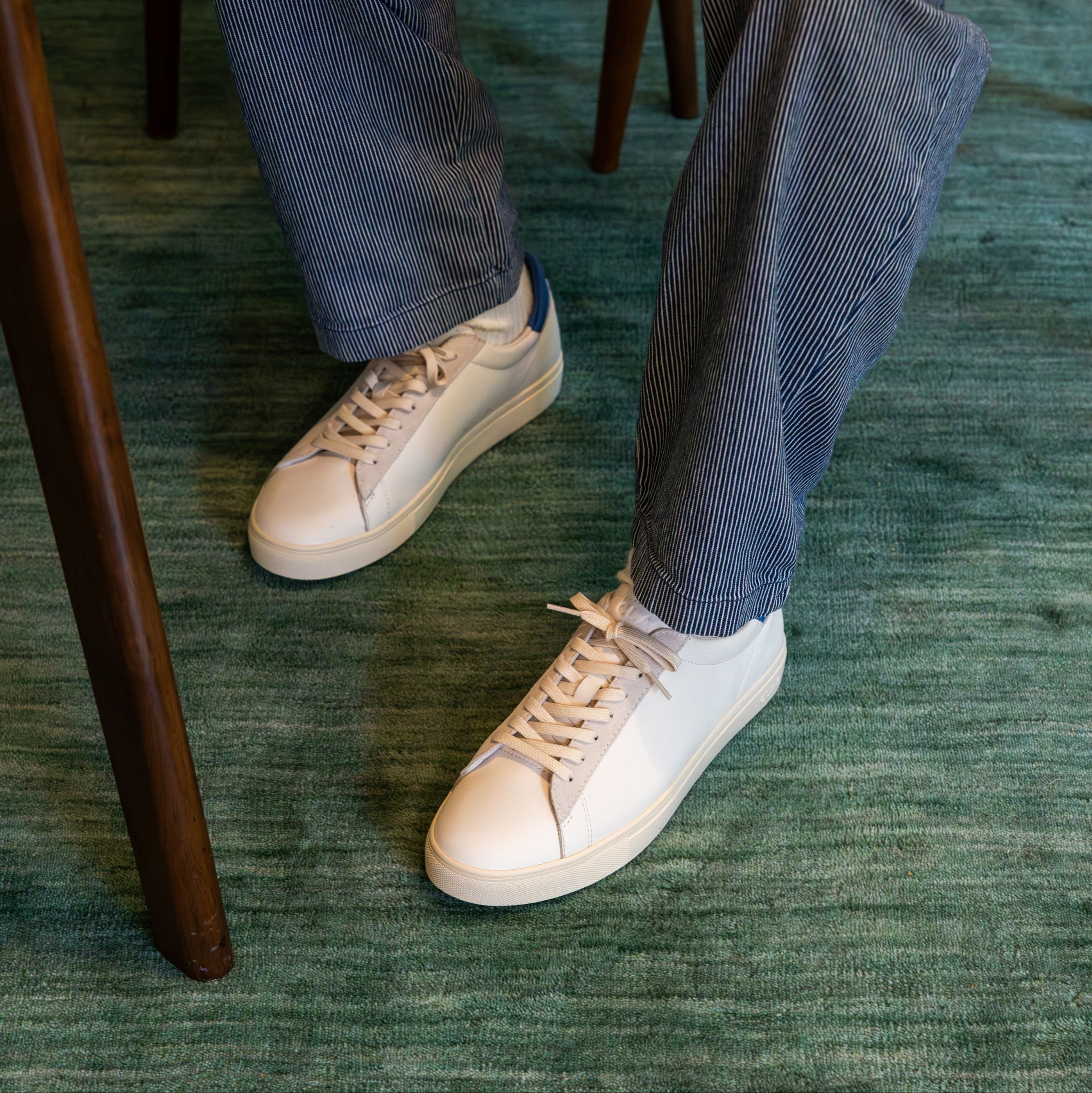 Bradley court shoe in White Pebble Blue worn in casual lifestyle setting, highlighting comfort, elegance, and premium materials.
