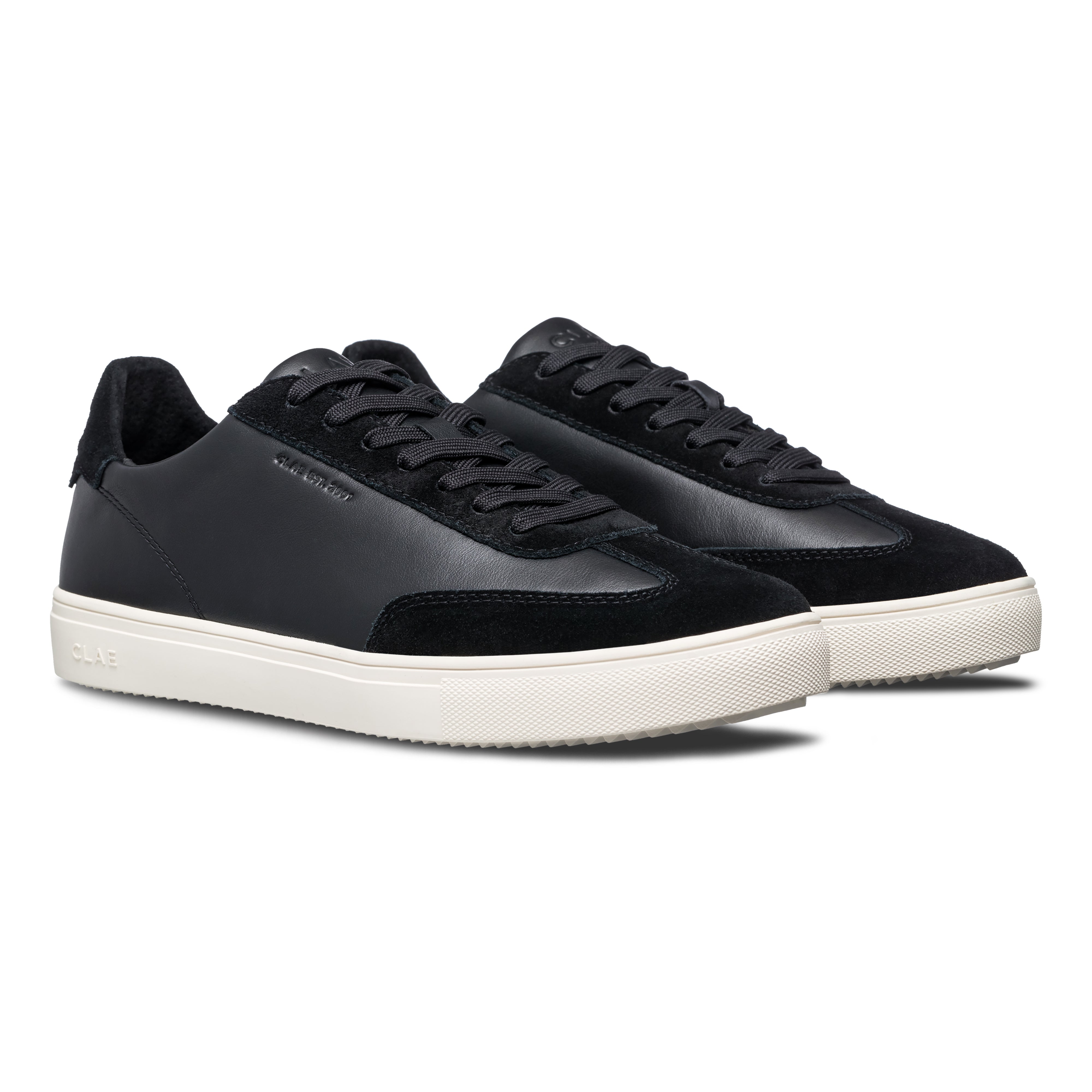 Three-quarter view of Deane court shoe in Black Off-White, highlighting sophisticated blend of materials and modern heritage design.